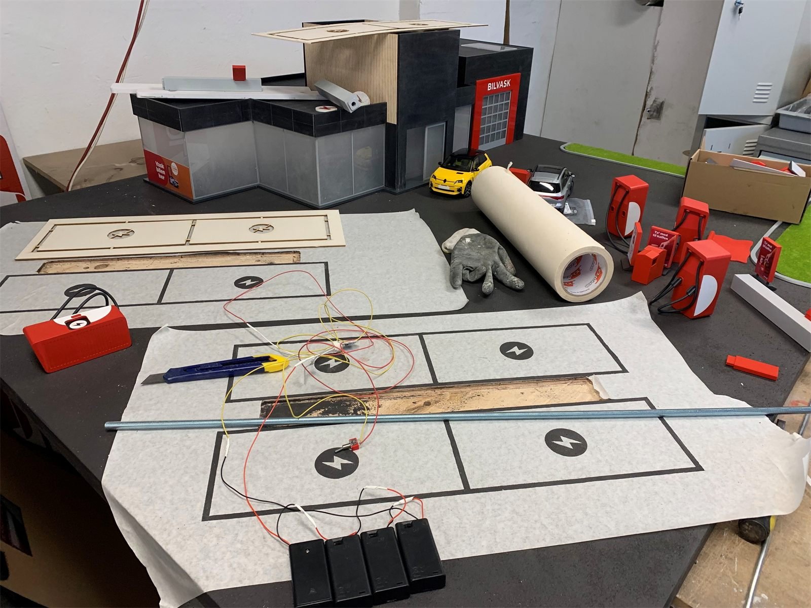Circle K commercial set model being wired and assembled on the workbench