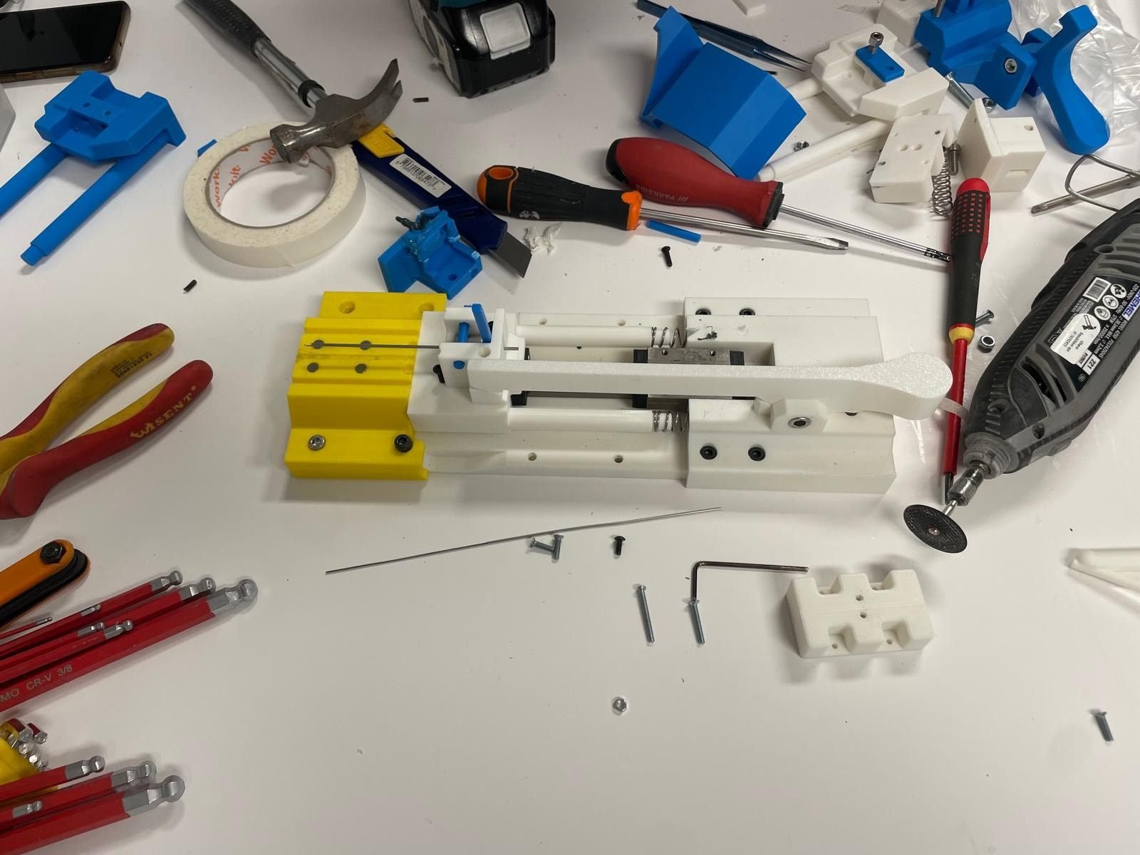Medical device prototype being assembled among tools on the bench