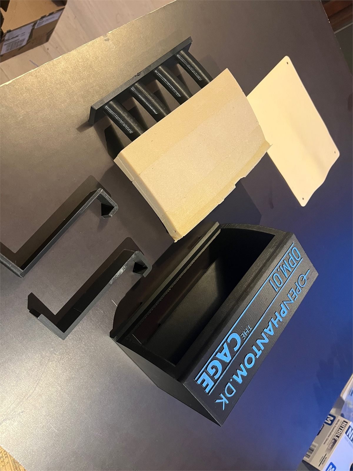 Parts of a needle training device laid out before assembly