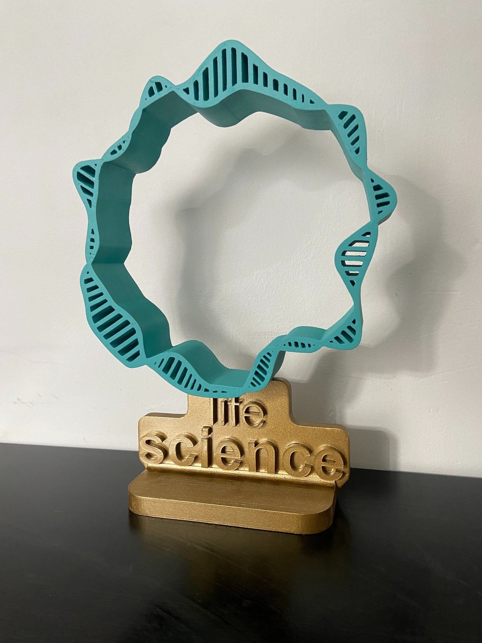 Custom life science award with a sculptural DNA ring on a gold base
