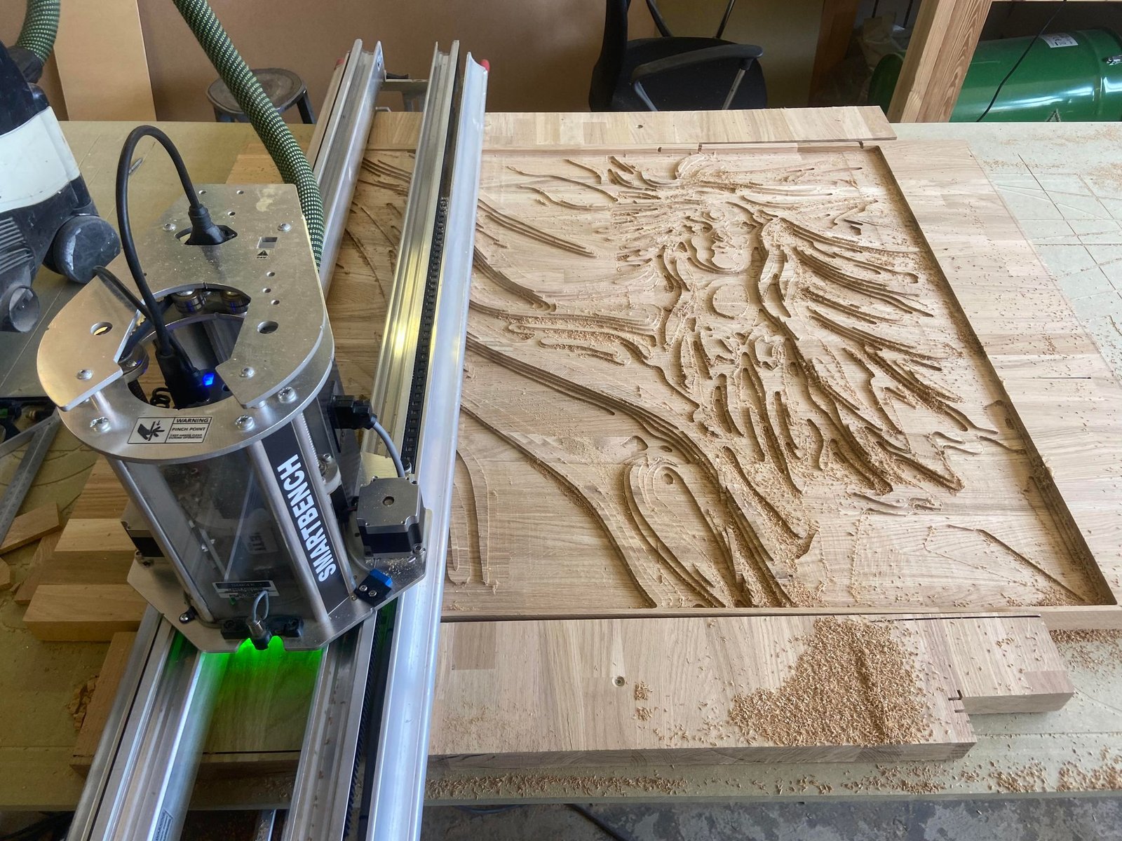 CNC router carving a wooden relief